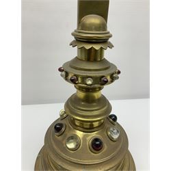 Brass alter cross, decorated with glass cabochons, upon a acicular stepped base and three claw feet, H73cm 