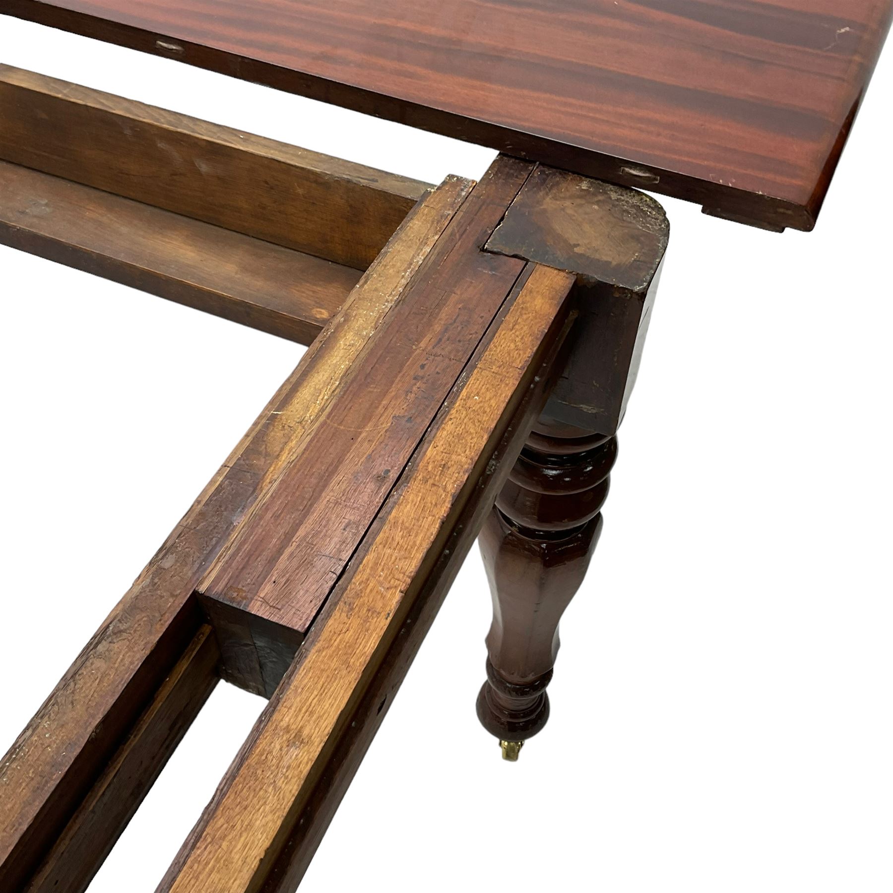 19th century mahogany extending dining table with three additional leaves, rectangular top with rounded corners, pull-out action, on turned and faceted supports with brass castors