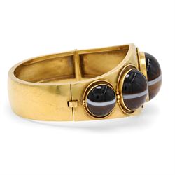 Victorian gold banded agate hinged bangle, set with five graduating cabochon cut agates, surrounded by wirework and bead decoration