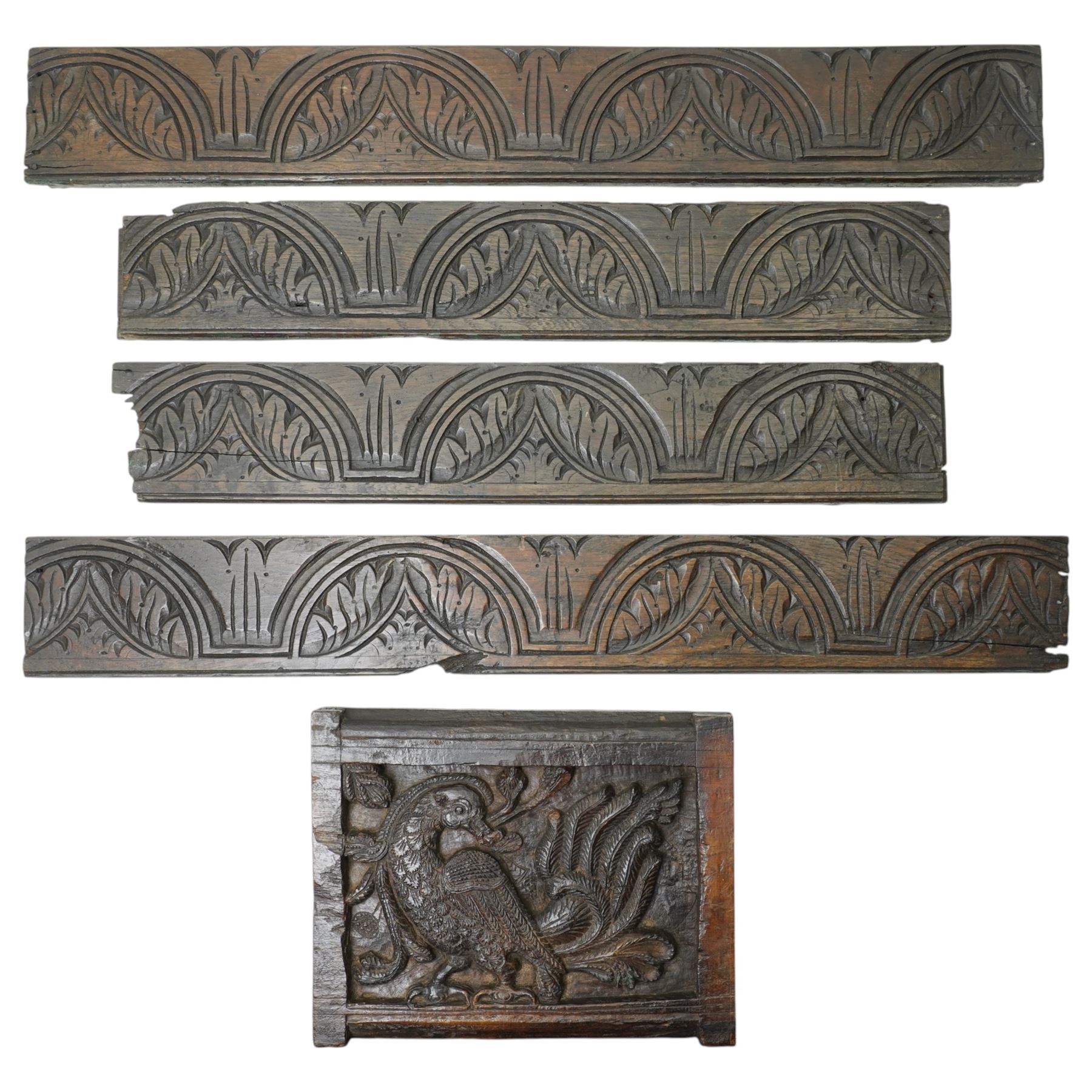Indian teak panel with bird and floral carving, c. early 18th century, W34cm; together with four friezes with reaping carved arch decoration, each approximately W71cm (5)