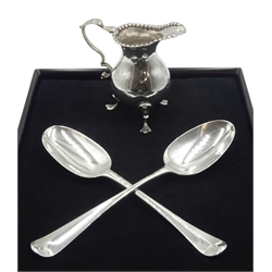 George III silver cream jug, leaf capped scroll handle, raised on three trefoil feet, London 1775, George I silver spoon, Hanoverian Rat Tail pattern, the reverse finial engraved P possibly by Charles Jackson, London 1725 and one other by Stephen Adams I, London 1773  approx 6.5oz