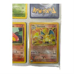 Collection of mainly vintage Pokemon cards including Charizard Base Set Holographic number 4/102 and two Ancient Mew 2000 promo cards, some housed within plastic wallets and some loose