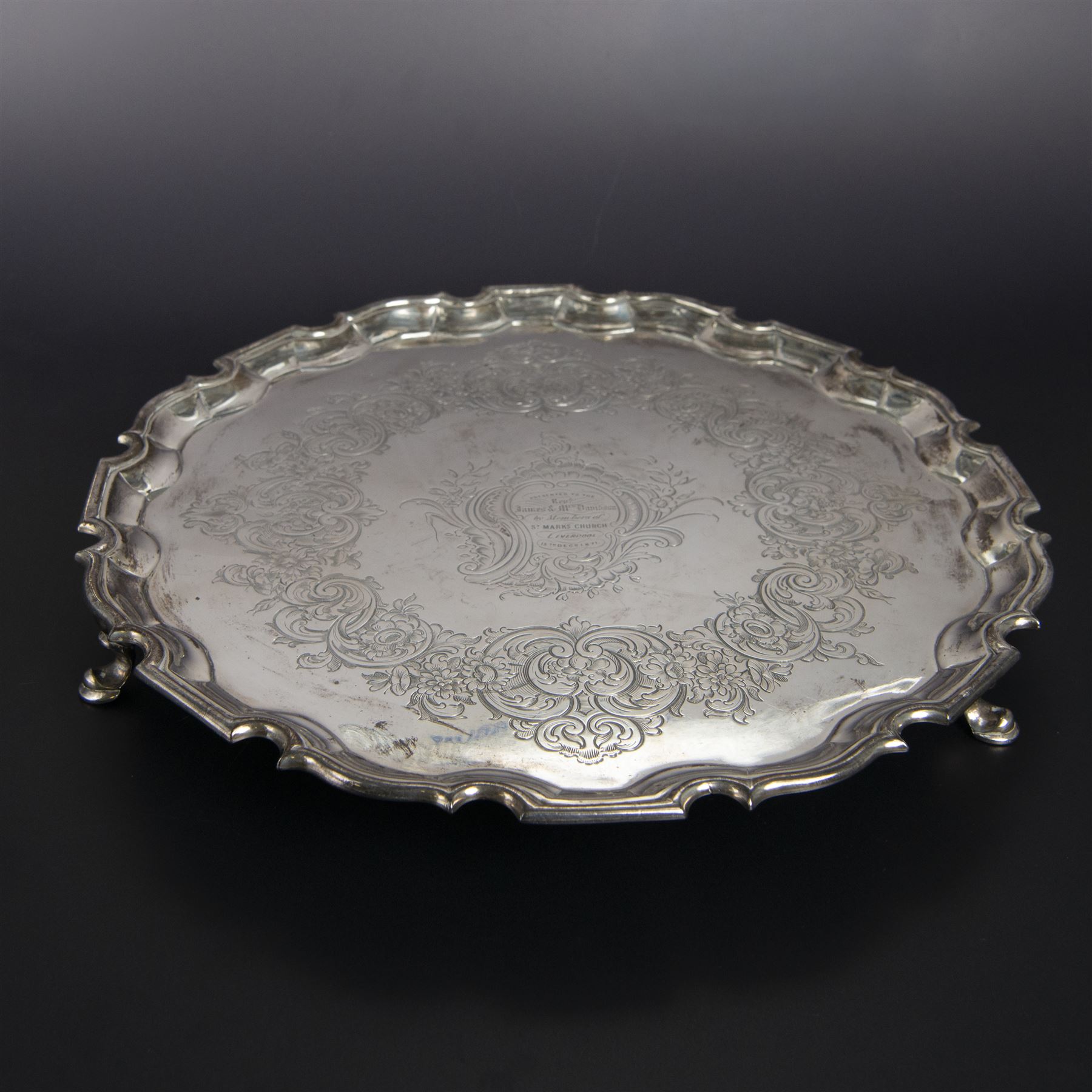 George II silver salver, of circular form with pie crust rim, with later floral and foliate decoration and presentation engraving to centre, upon three stepped feet, hallmarked William Peaston, London 1749, D30cm