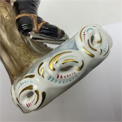 Royal Crown Derby figurine, Winter, modelled as a man with crossed arms on ice skates, by M. Townsend, with printed marks beneath, H24cm