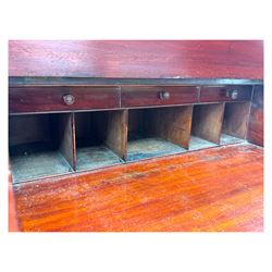 Large Victorian mahogany Registry/Dickens’ desk, spindle gallery top, one side with five small drawers and the other with blind cupboard drawer, revealing pigeon holes with scroll carved locking side bars on either side, above a hinged and leathered writing slope with three drawers and pigeon holes underneath, above a central locking drawer with key, the pedestals each with four drawers and  turned knob handles, separates into four parts for transport