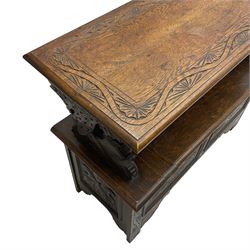 Early 20th century carved oak monk's bench, hinged moulded top carved with lunettes on dolphin supports, hinged box seat, the panelled front carved with foliate lozenges