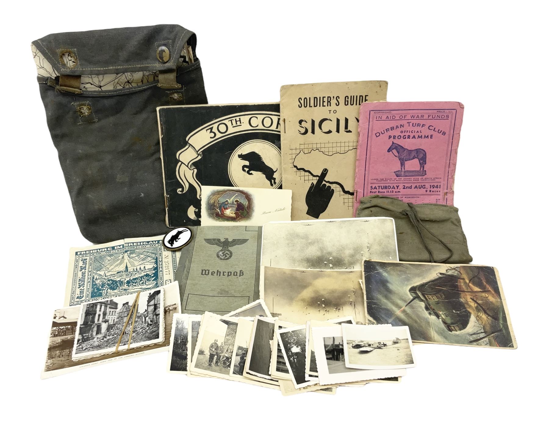 WW2 German War Pass (Wehrpass) identification paperwork for Walter Fensterseifer 2nd type booklet dated 8/6/1940, with signed photo of recipient in civilian suit. Born 31st January 1921. Numerous entries; together with quantity of small private photographs of German soldiers; One Million mark banknote 1923; 30th Corps in Germany booklet with Formation badge; and other WW2 paper ephemera