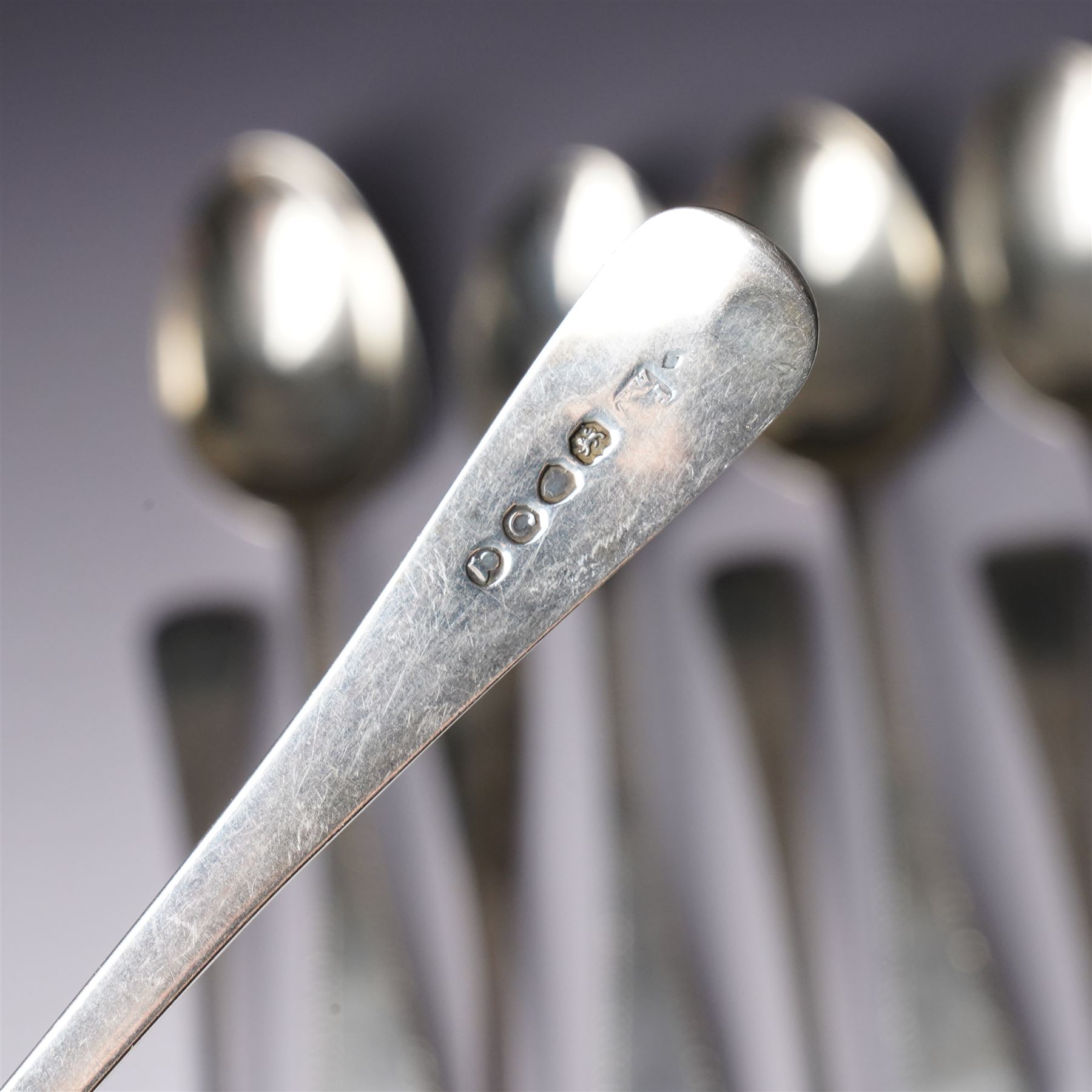 Set of six George III silver dessert spoons with bright cut stemsLondon 1818 Maker Thomas Wallis II and Jonathan Hayne, three other silver dessert spoons and a silver berry spoon with gilded bowl (10)