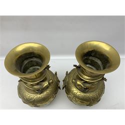 Pair of Chinese brass vases, of ovoid form with elongated neck and fluted rim, decorated in high relief with a dragon chasing a flaming pearl around the neck, the body with dragons, birds and buildings, with character marks beneath, H25cm