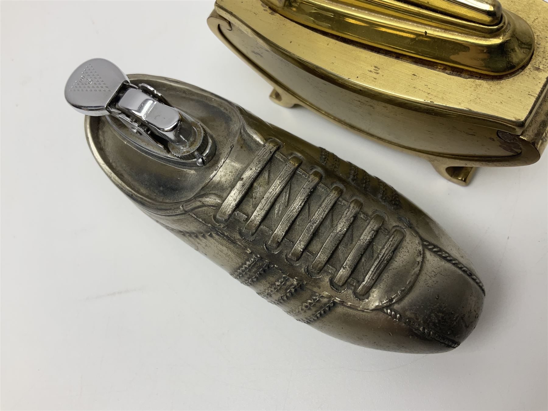Ronson gilt metal table lighter, together with a silver-plate table lighter in the form of a football boot