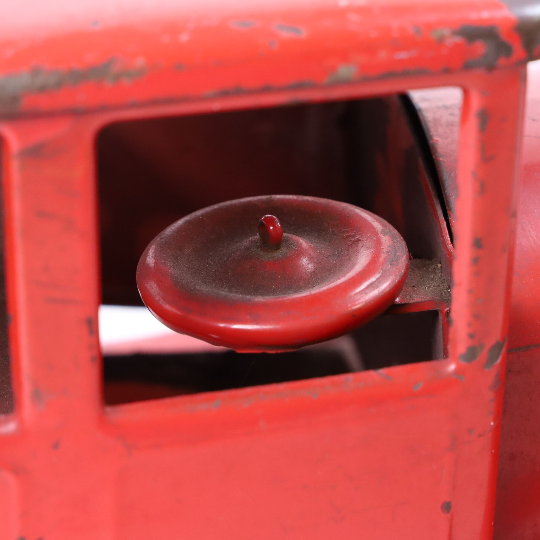Tri-ang/Line Bros Ltd tin plate tipper truck, red body with black rubber wheels and red seat and steering wheel to interior, H49cm, L16cm