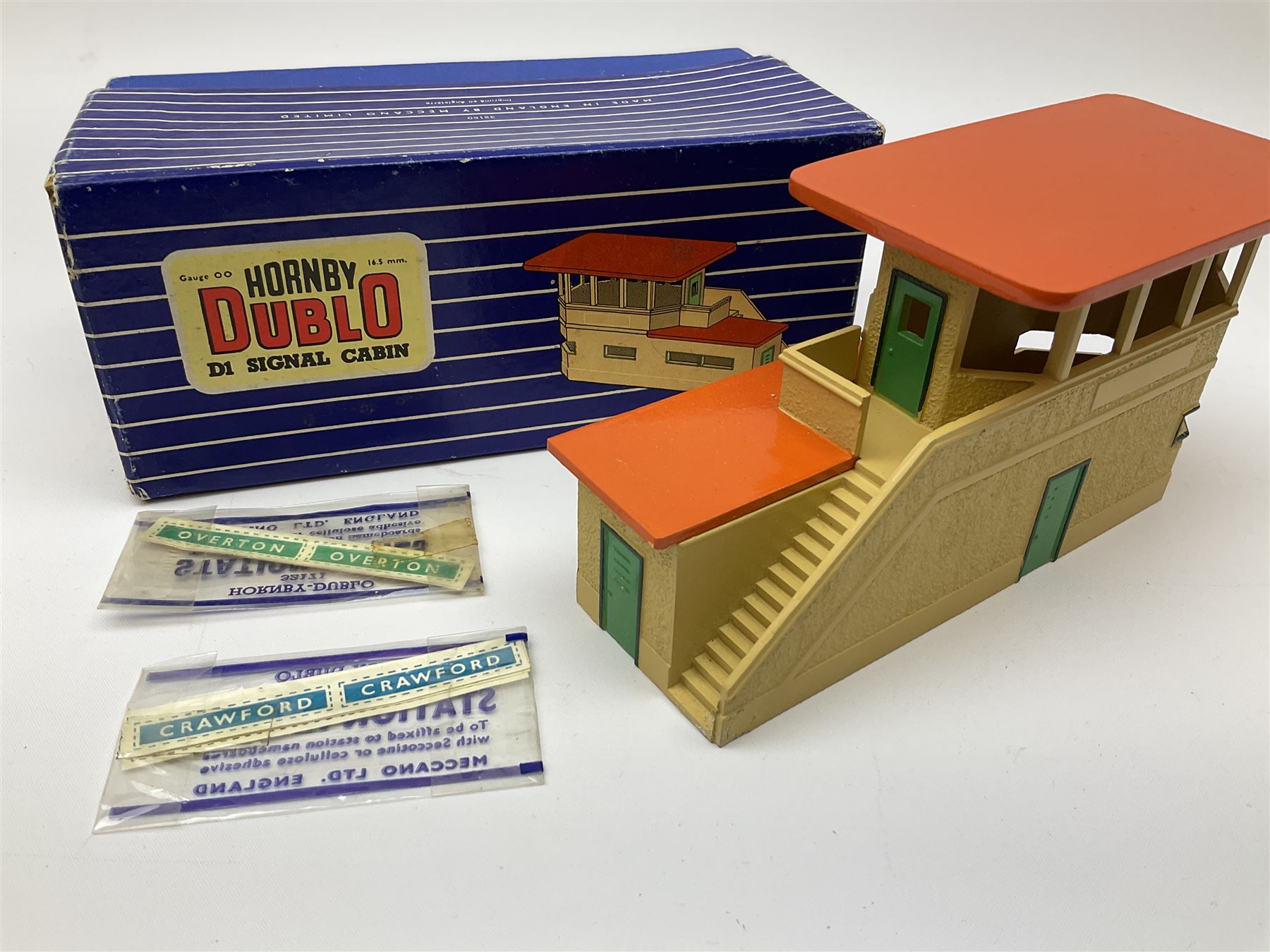 Hornby Dublo - six D1 accessories comprising Turntable; Through Station with separately boxed Platform Extension with Wall; Signal Cabin with orange roof and two packs of station names; Level Crossing; and Island Platform; all boxed (6)