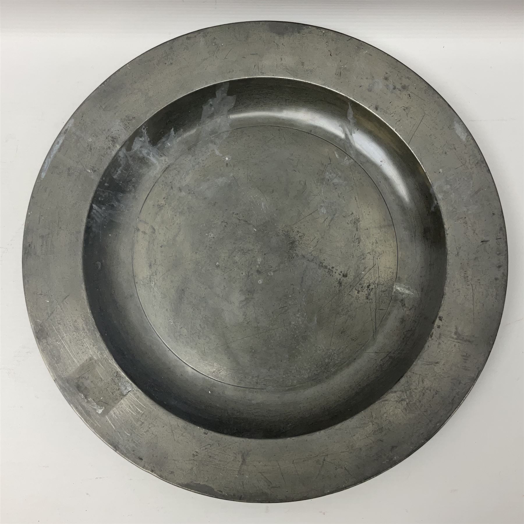 Group of seven 19th century pewter chargers, each of circular form with dished centre, two examples with touch marks verso, each approximately D39cm