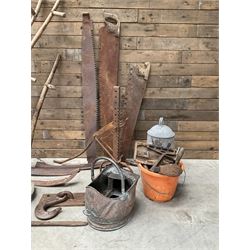 Large quantity of vintage hand tools including scales, scythes, saws etc