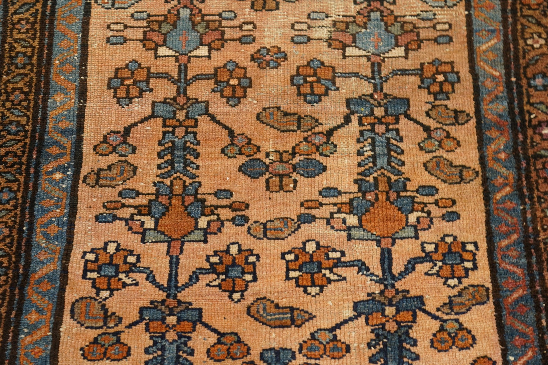 Collection of four Persian rugs, comprising a Saraband ivory ground rug with all-over boteh field and multiple borders; a crimson ground Hamadan type rug with all-over stylised floral and geometric motifs; a floral medallion prayer rug with dark field and ivory spandrels; and a Hamadan peach ground rug with repeating stylised flowering plants and dark multiple borders, largest 83cm x 142cm