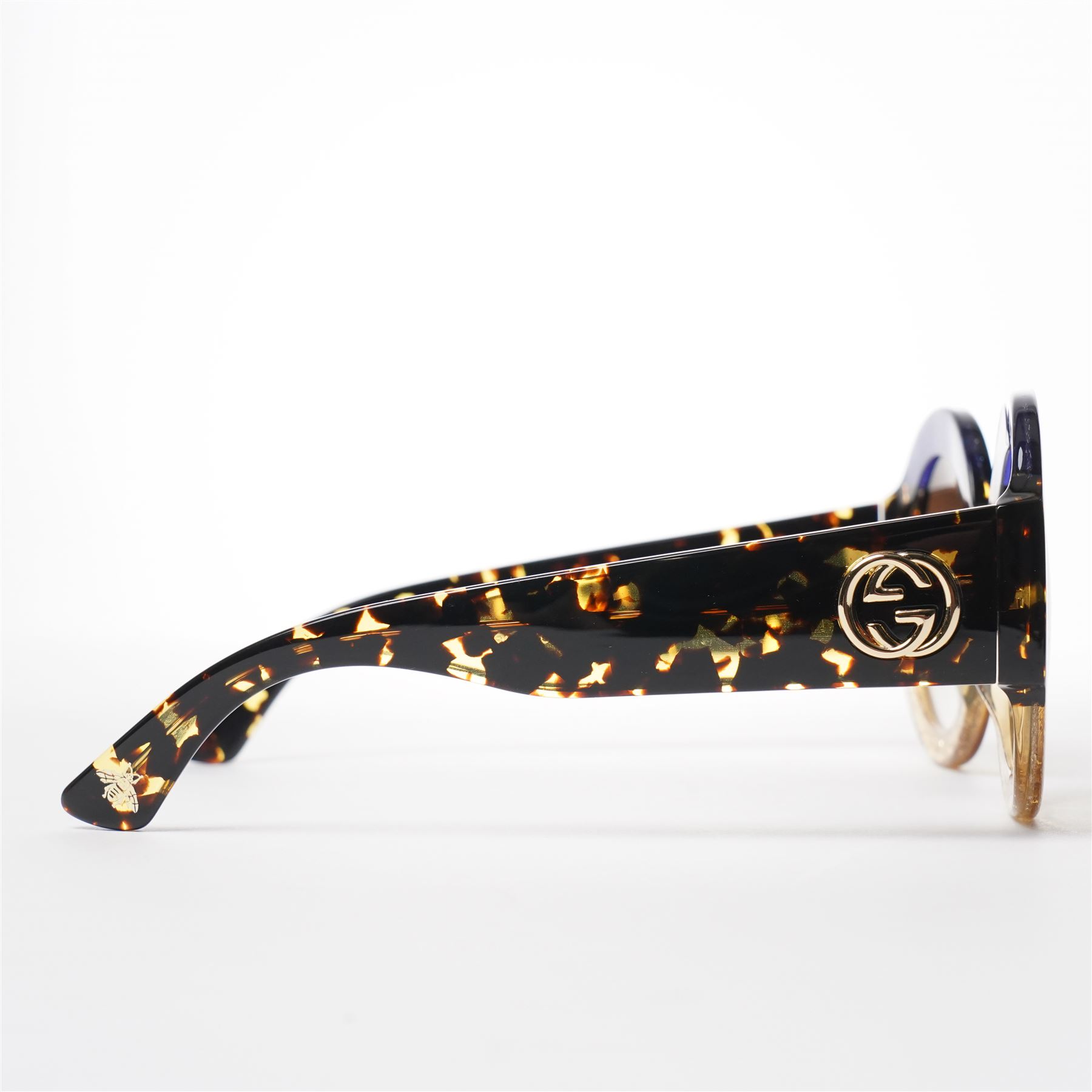 Gucci - pair of oversized round sunglasses, with gradient tinted lenses in a tortoiseshell-effect frame with blue and gold glitter inlay, the temples with interlocking gold-tone GG logo and bee motif, unused with original cloth and hard cases