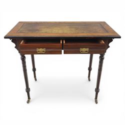 Edwardian mahogany writing table, tooled leather top over two frieze drawers, on turned supports terminating in castors