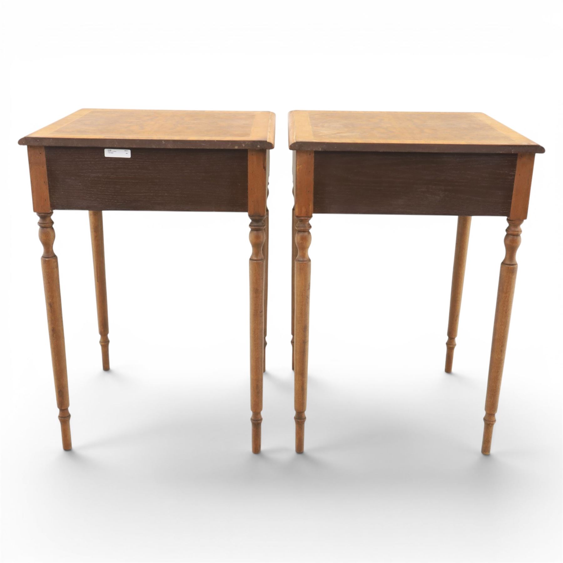 Traditional design pair of walnut lamp tables, figured top with crossbanded edge, above a single frieze drawer with brass oval handles, raised on turned supports