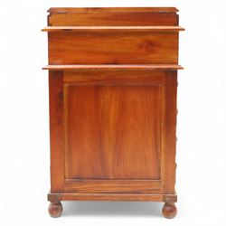 Victorian design mahogany Davenport desk, the sloped writing surface inset with tooled green leather and hinged to reveal a fitted interior, with a pen compartment to the raised gallery back, four drawers to each side, on carved scrolled supports with acanthus detail, raised on turned feet