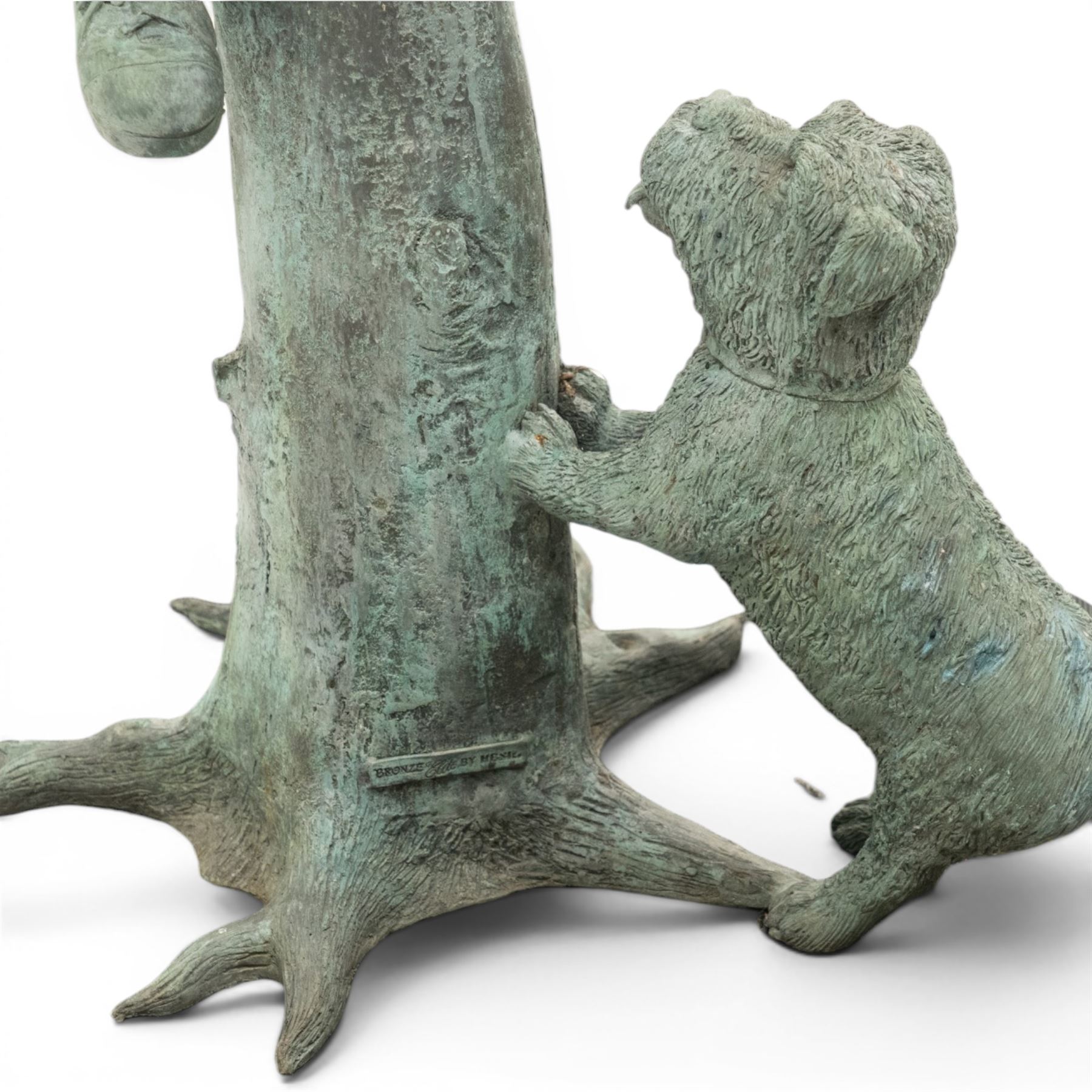 After Eneri Prosperi, bronze garden letterbox, modelled as a seated boy reading on a tree stump, with rustic post box with mail indicator, dog at his feet, textured verdigris finish throughout