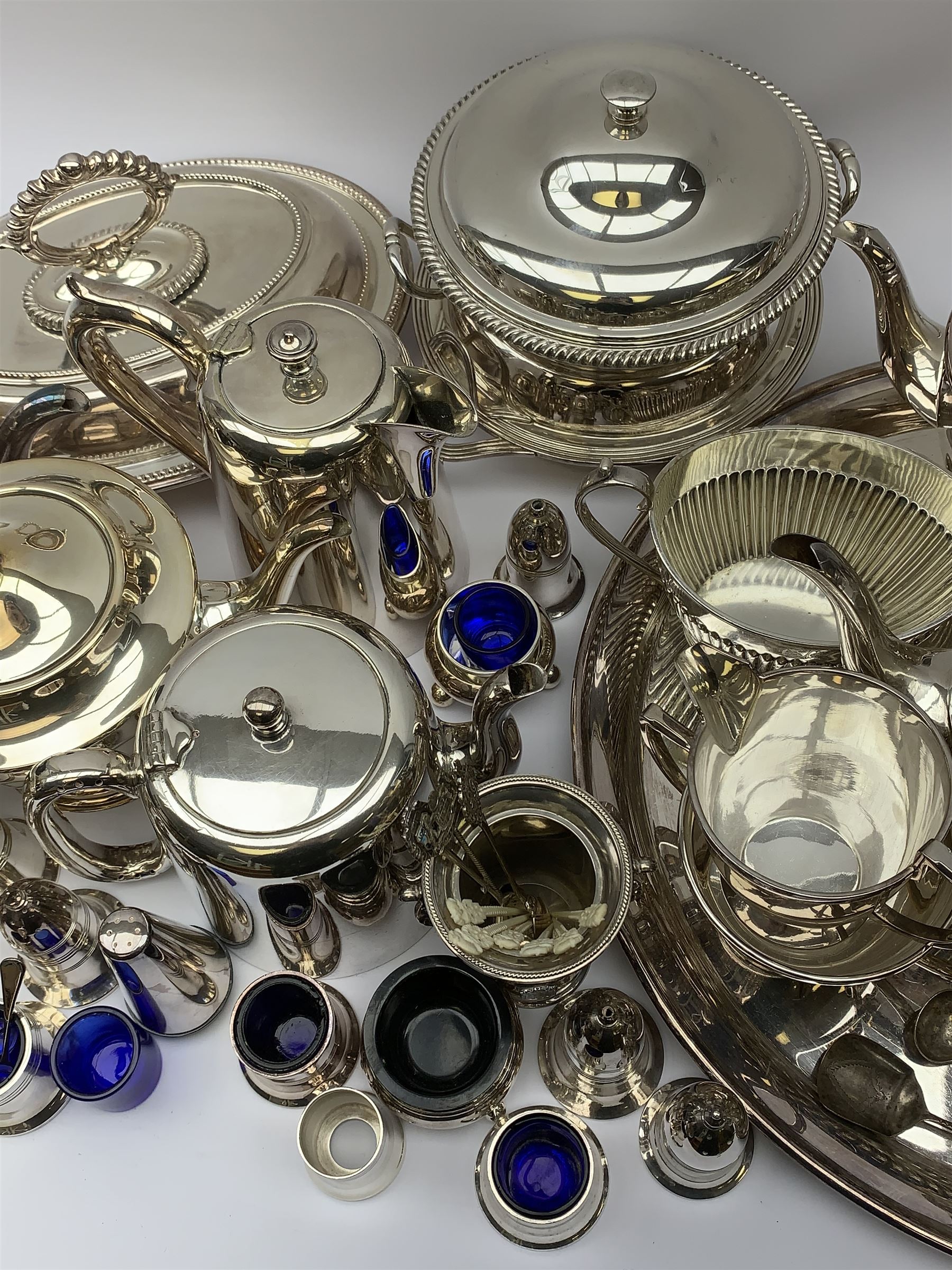 Mappin & Webb Art Deco style four-piece silver-plated tea set, a Mappin & Webb three-piece Princes Plate tea set of half fluted form with engraved monogram, two silver-plated entree dishes, circular tea tray, part cruets and other plated wares 