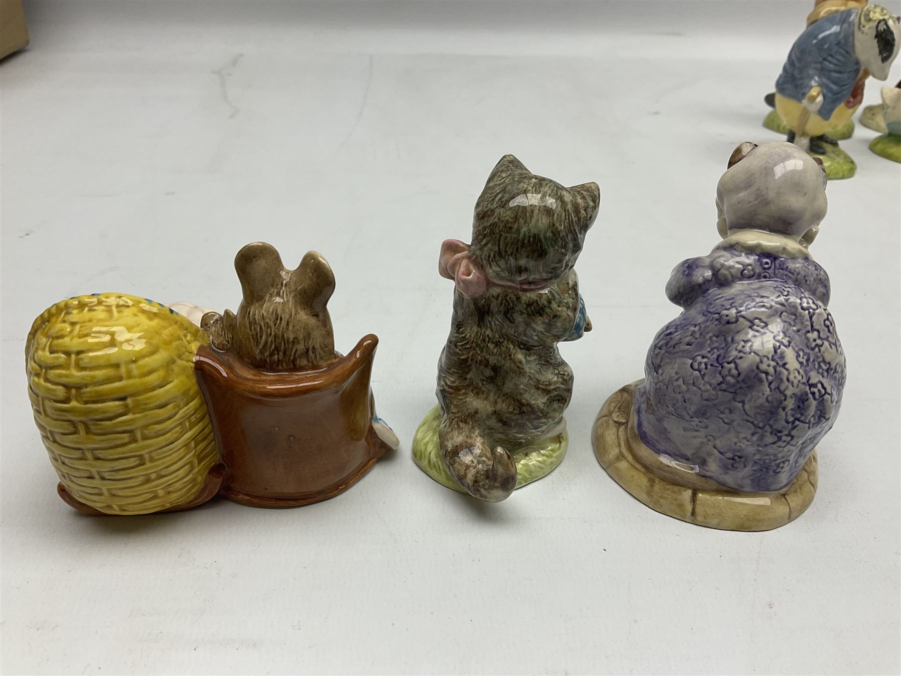 Six Beswick Beatrix Potter figures, comprising Miss Moppet, Tommy Brock, Peter Rabbit, Cecily Parsley, Mr Drake Puddle-Duck, Amiable Guinea Pig, together with four Royal Albert figures, Hunca Munca, Lady Mouse made a curtsy, Little Pig Robinson and Mr McGregor, all with printed mark beneath  (10)