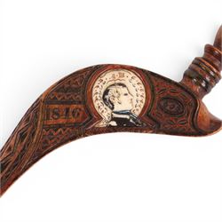 19th Century fruitwood goose-wing knitting sheath, decorated with geometric patterns, with a inset bone bust initialled A.B, together with a carved peg knitting stick, sheath L26cm