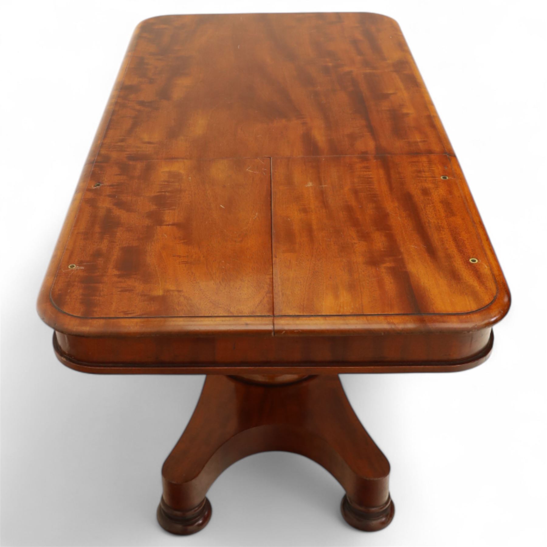 William IV mahogany reading table, the rectangular top with rounded corners and moulded edge, one end fitted with two hinged adjustable reading slops with two rests, the sliding top with a sprung stay mechanism, supported on a single tapered faceted column  with turned collar on a quatreform base with compressed bun feet