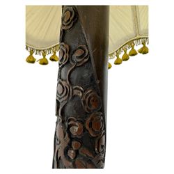 Early 20th century floor lamp, with fringed and pleated silk shade over a carved and turned column, on a circular stepped base