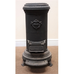  Cast iron cylindrical heating stove, top loading, lift up ashbox door, scrolled feet   