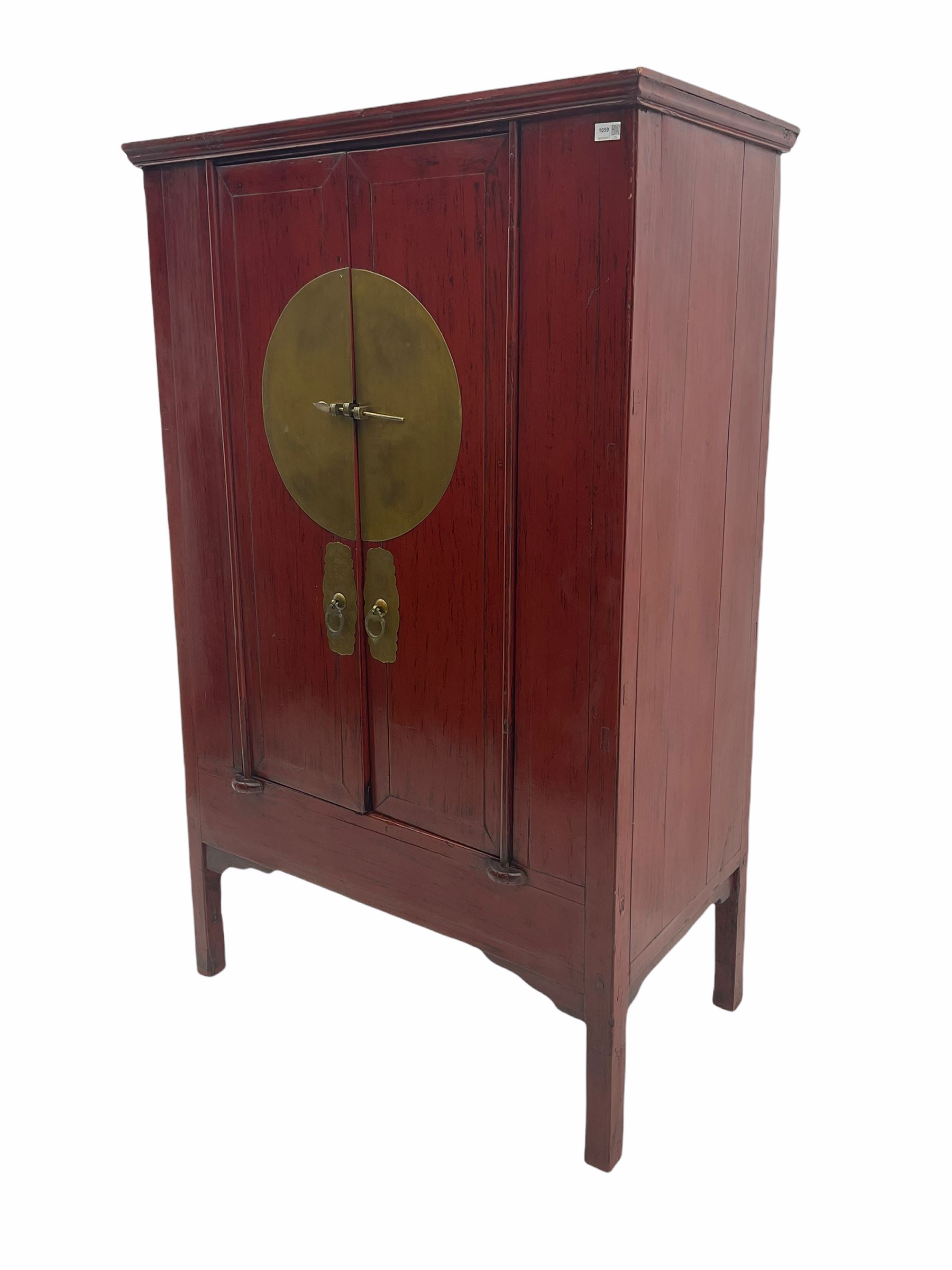  Chinese red lacquered elm and pine Moon marrige cabinet, enclosed by two doors, brass metalwork and hinges
