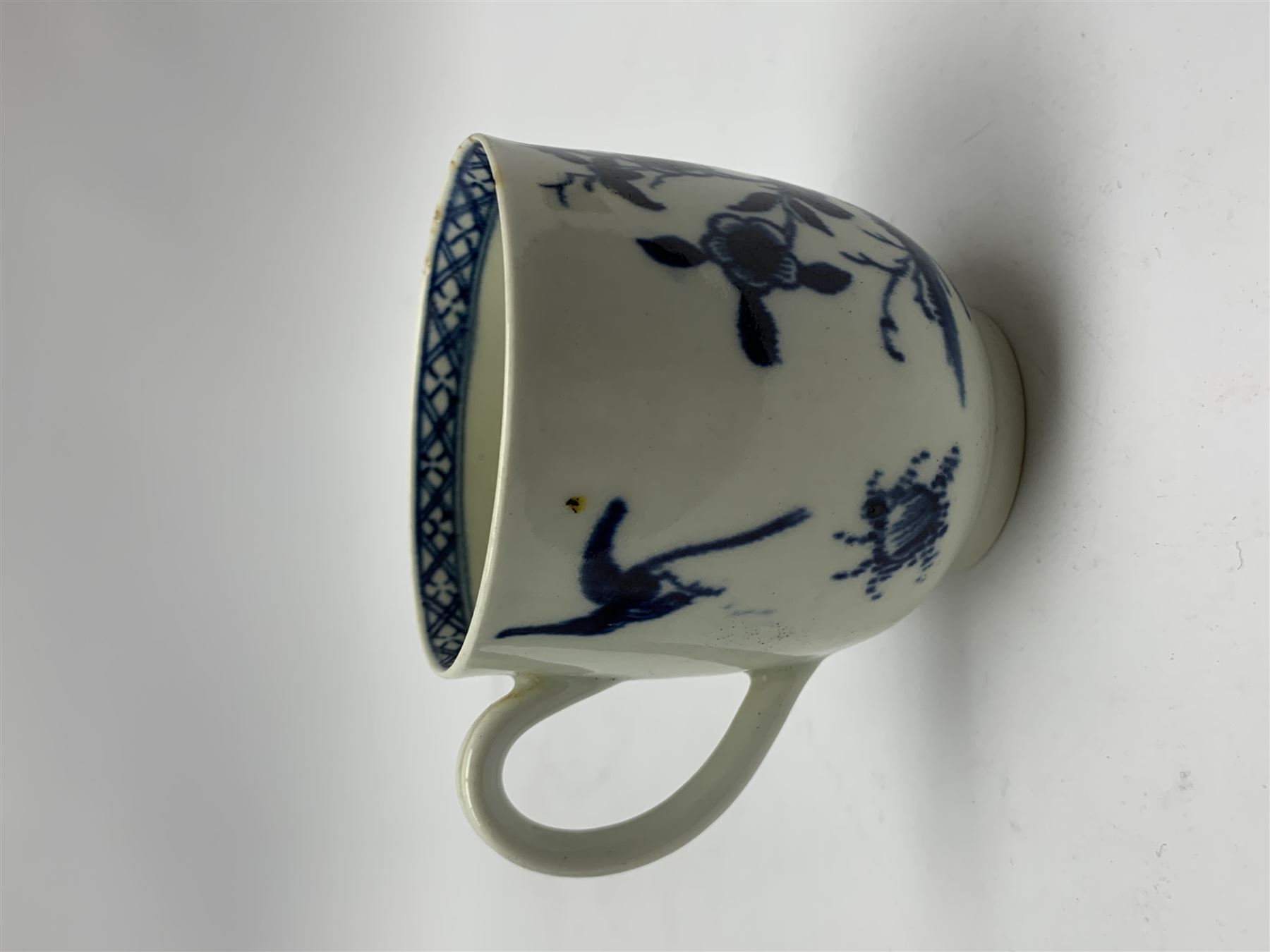 18th Century Worcester teapot, circa 1765-70, decorated in the Bird in the ring pattern, the cover with bud finial, with crescent mark beneath, H13cm, together with a Worcester coffee cup decorated in the same pattern, with crescent mark beneath, H6.5cm