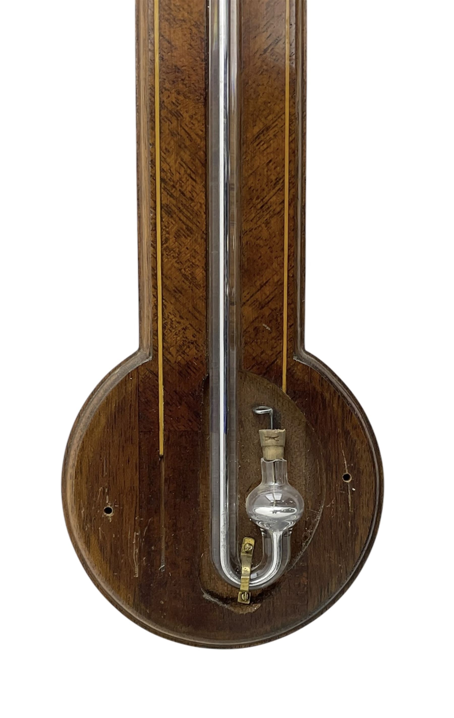 Comitti-20th century mercury stick barometer in an 18th century style mahogany case with satinwood stringing, with a broken pediment, brass finial and round base, silvered register with recording vernier, weather predictions and a centigrade/Fahrenheit spirit thermometer enclosed within a glazed door, visible tube with a bulb cistern and turned mahogany cover.
Mercury clean and present with no air locks.
