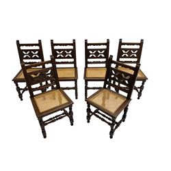 Set six early 20th century oak chairs, the uprights carved with foliage motifs, fretwork back with flower head roundel, cane work seat, on turned supports joined by turned stretchers 
