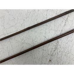 Native long-shafted spear, the large iron head with central medial ridge and decorative neck, on plain circular haft L260cm; and another similar Native long-shafted spear with cane haft L249cm (2)