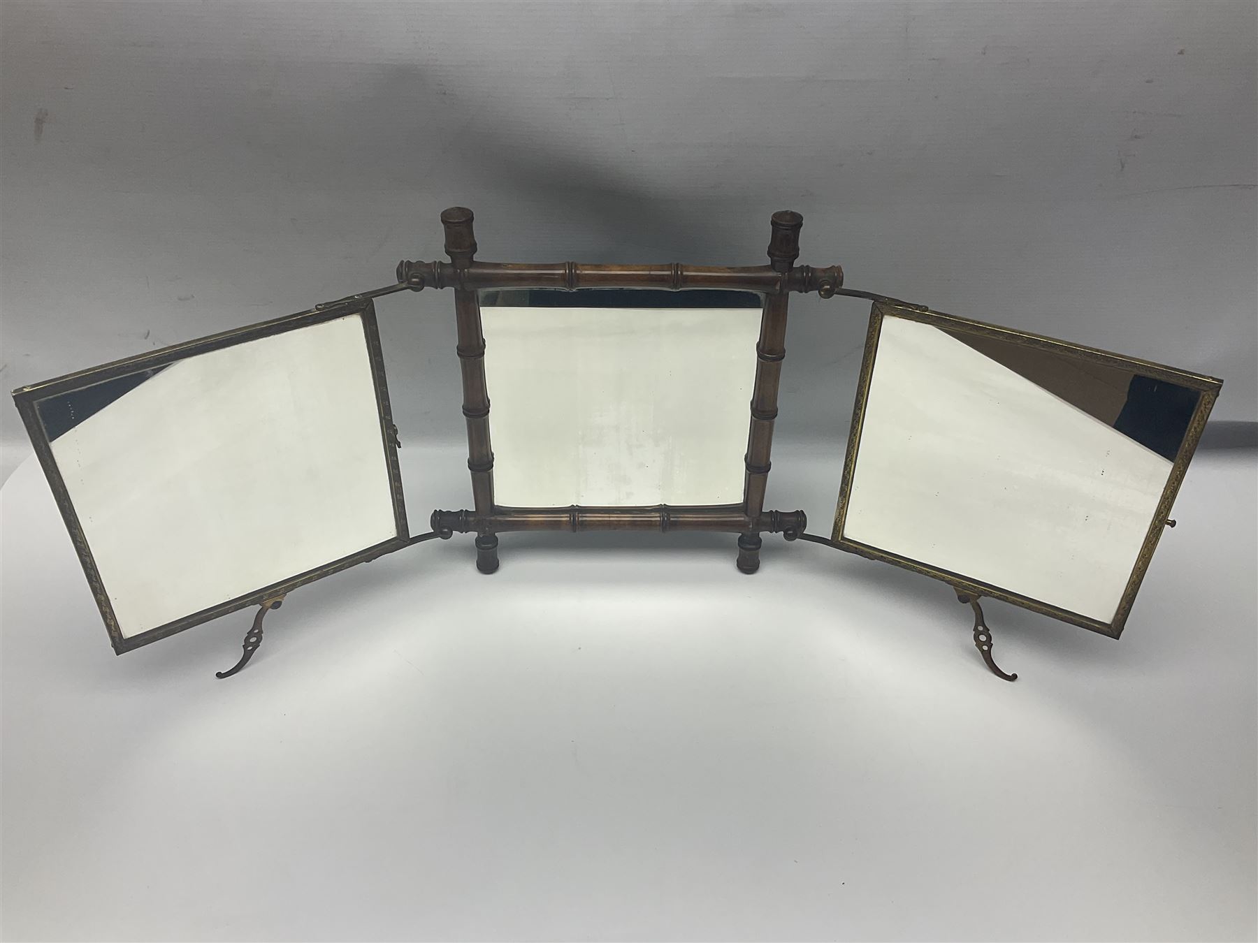 Japaneses triptych mirror, with two fold out panels with prints depicting egrets and figures in a garden with Japanese text, within a bamboo frame, H32cm