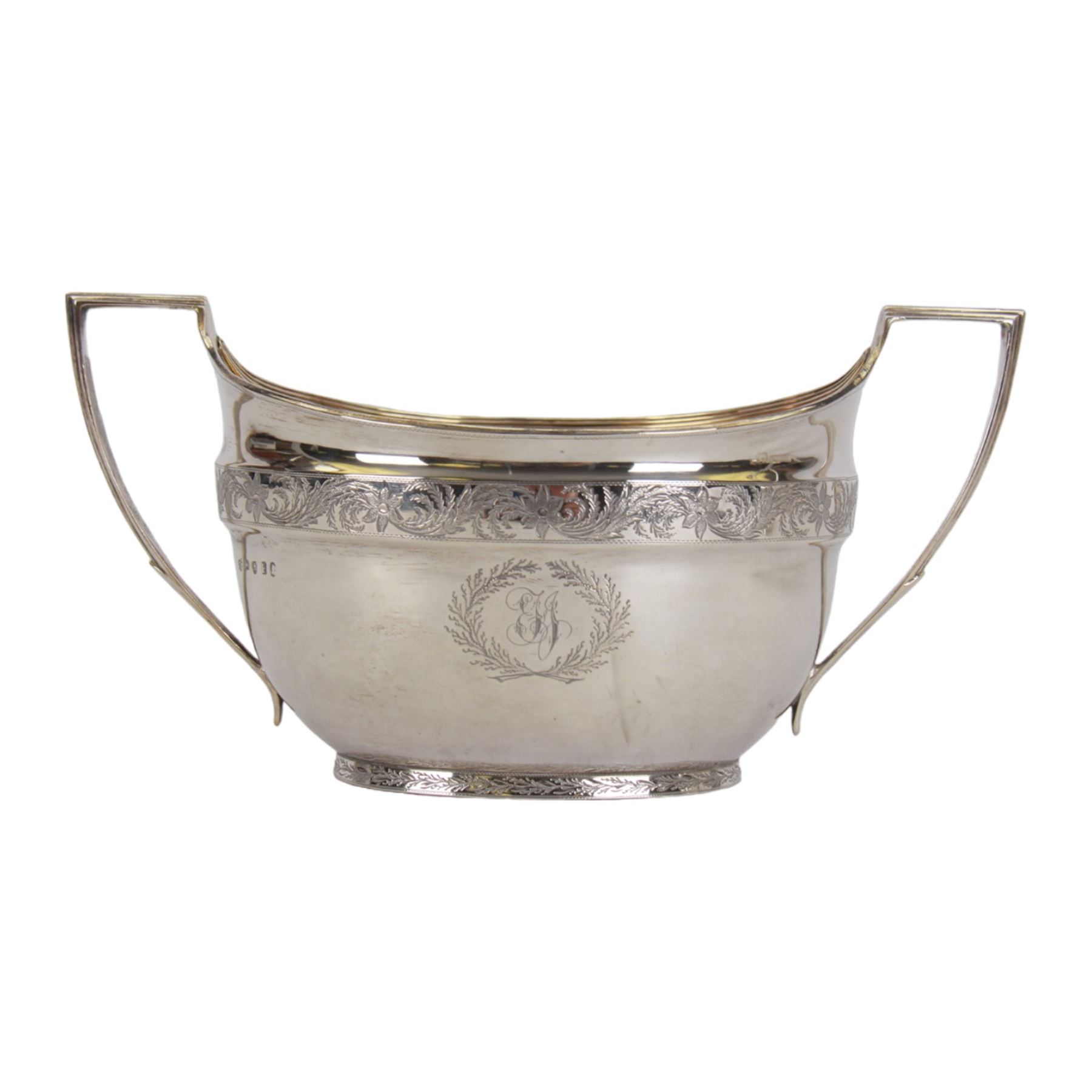 George III silver three piece tea service, comprising teapot with ivory scroll capped curved handle and ivory finial to the hinged cover, twin handled open sucrier with gilt interior, and cream jug with gilt interior, each of oval form with rounded sides, the bodies engraved with central monogram within a seaweed wreath, between engraved foliate bands, hallmarked John Emes, London 1801, teapot including handle H17cm

This item has been registered for sale under Section 10 of the APHA Ivory Act