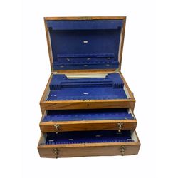 An oak canteen case with recessed twin drop carry handles, the hinged cover opening to reveal a canteen interior, above two pull our drawers, H25.5cm, together with a further smaller canteen case, (both vacant), and two part canteens of Community plate cutlery. 