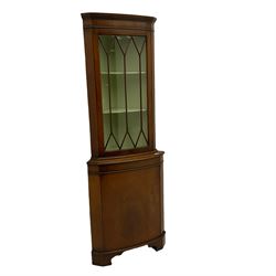 20th century mahogany corner display cabinet,  projecting cornice, dentil frieze, single glazed door enclosing two shelves, above single cupboard door , shaped bracket supports