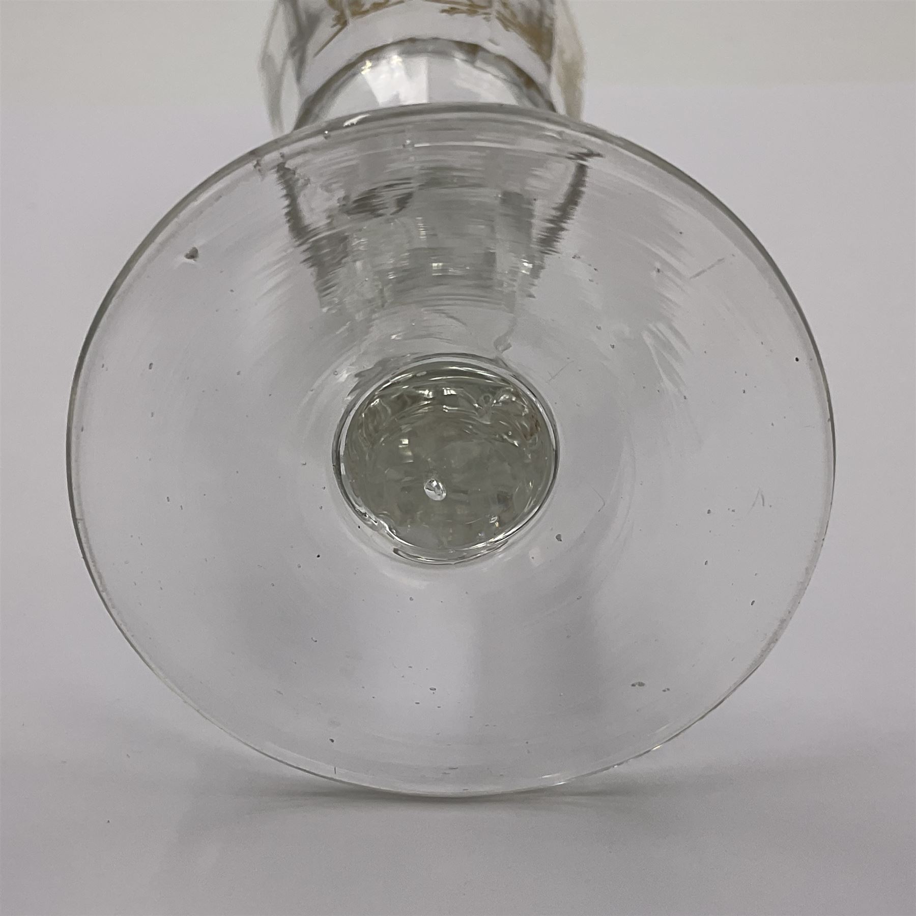 Three 18th century wine glasses comprising a plain stemmed glass with bell shaped bowl and conical folded foot H16cm, another plain stemmed glass with ogee bowl and folded foot and a Continental glass with gilt faceted bowl, decorated with male figure within a landscape, on a clear Silesian seven sided cut stem (3)