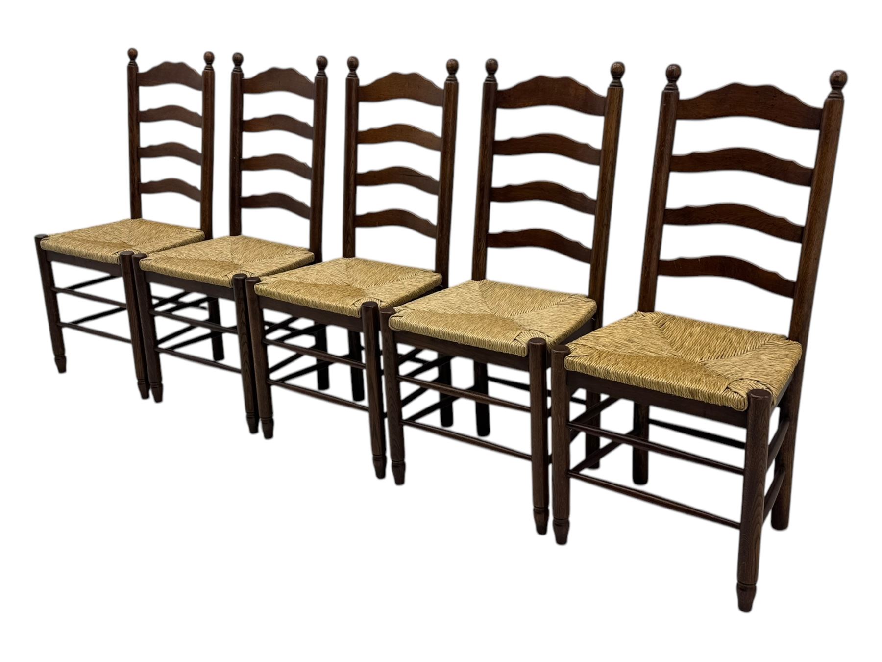 Set of ten 18th century design oak ladder back dining chairs, shaped cresting rail over four horizontal splats, rush seat raised on turned supports united by double stretchers