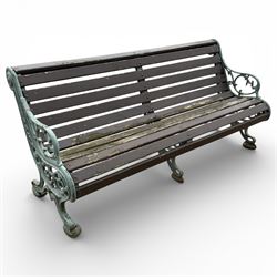 Victorian cast iron garden bench with dark wooden slats and ornate green painted ends.