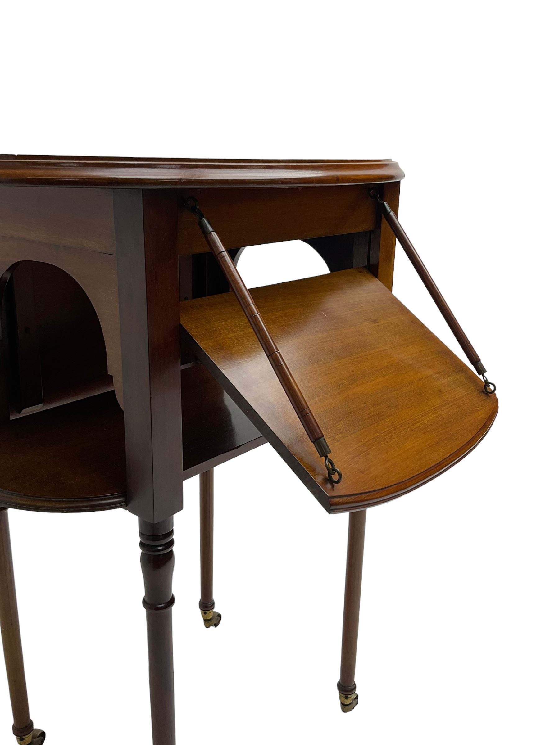 An unusual Edwardian mahogany drop leaf centre table, oval form with two drop leaves on sliding