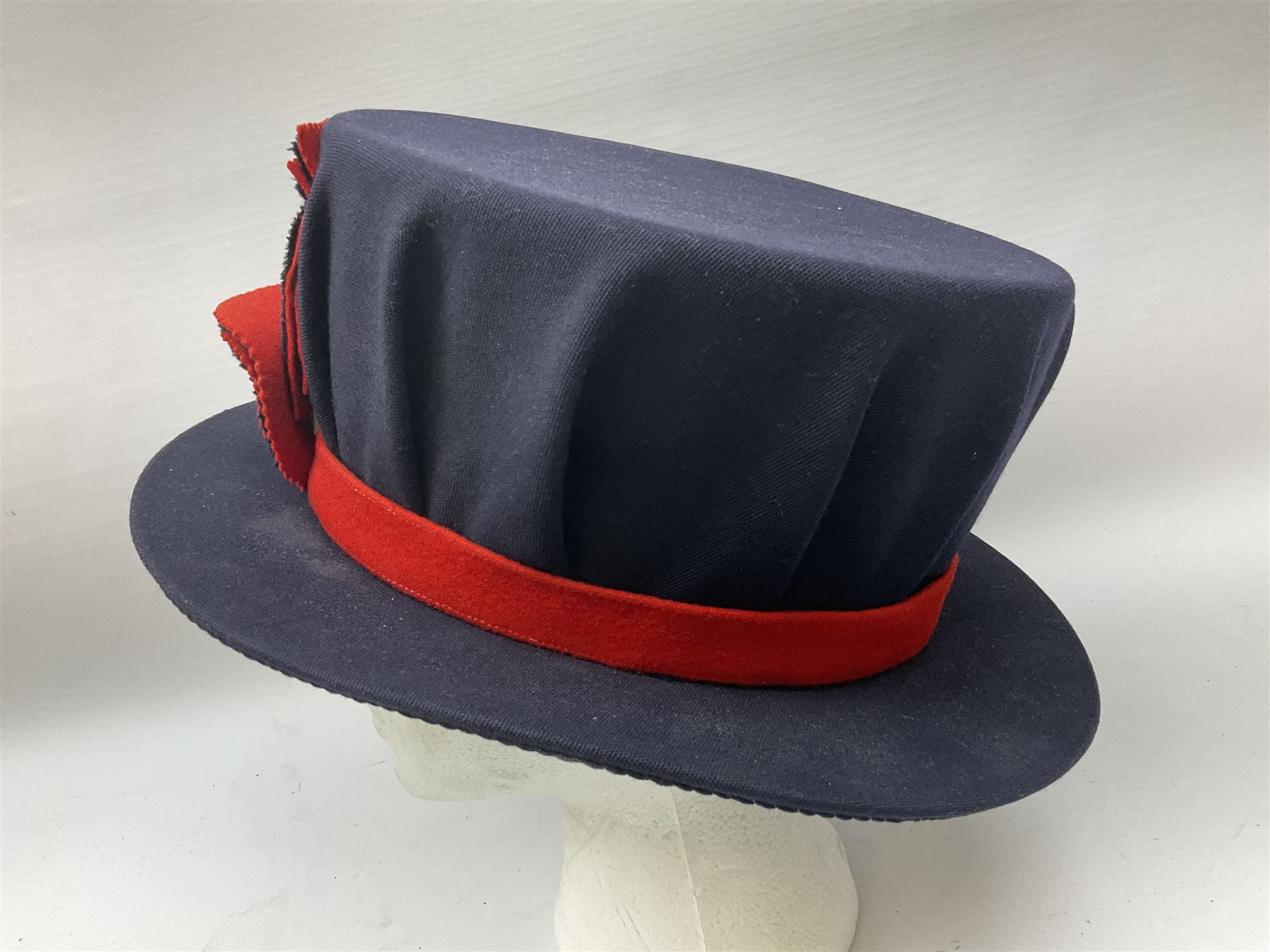 Elizabeth II Yeoman Warders (Beefeater) No.1 Undress blue uniform - comprising tunic bearing label Crown Military Uniforms H.M. Tower of London and bonnet by S. Patey (2) 