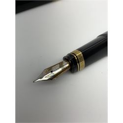An Omas 360 fountain pen, the black triangular section body with gold coloured clip and banding, and Greek Key border to the cap, the bicolour nib marked 750 18K.
