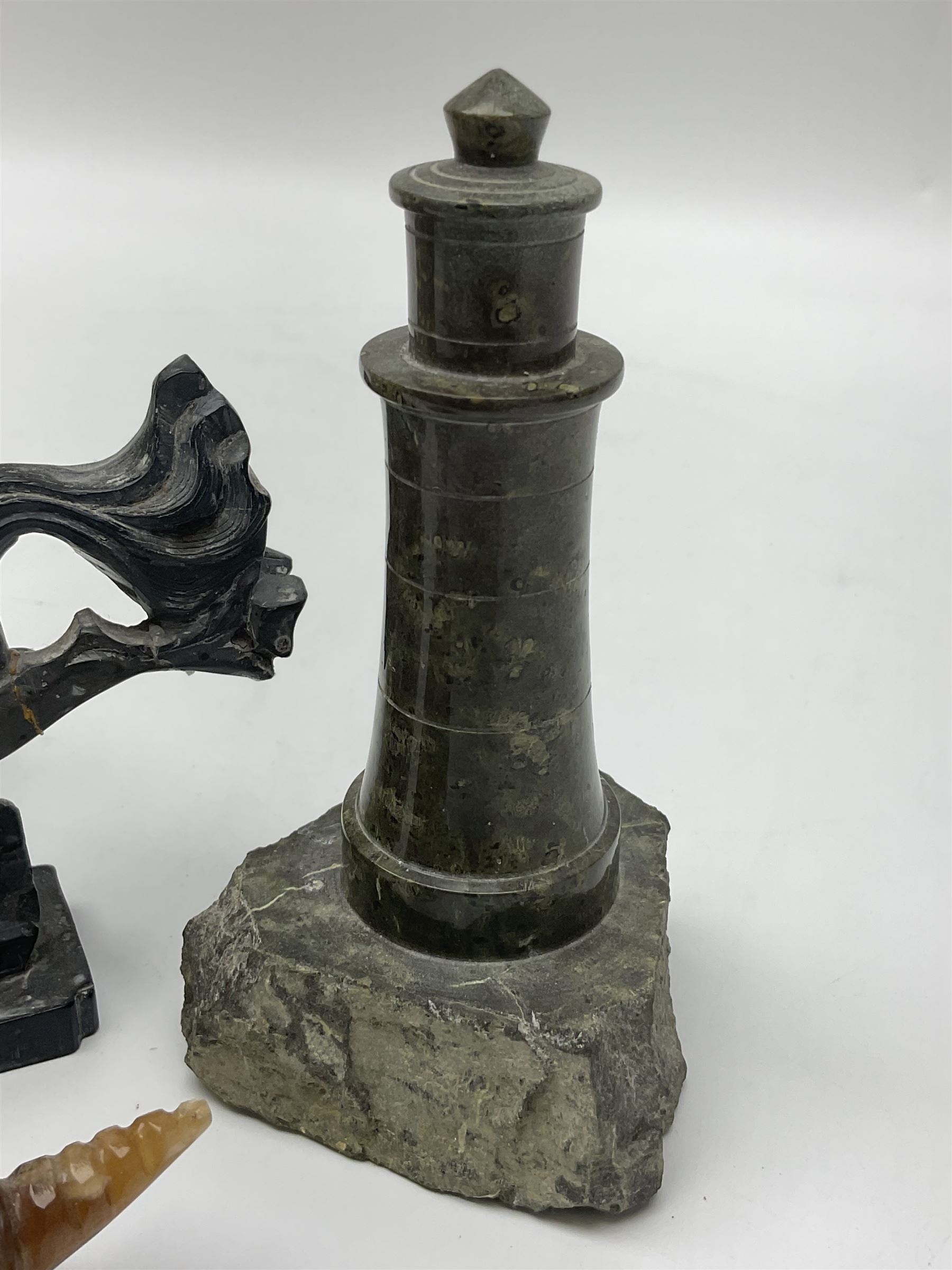 Cornish carved serpentine model of a lighthouse, together with a Chinese soapstone figure of a horse, another carved horse figure and a carved hardstone armadillo