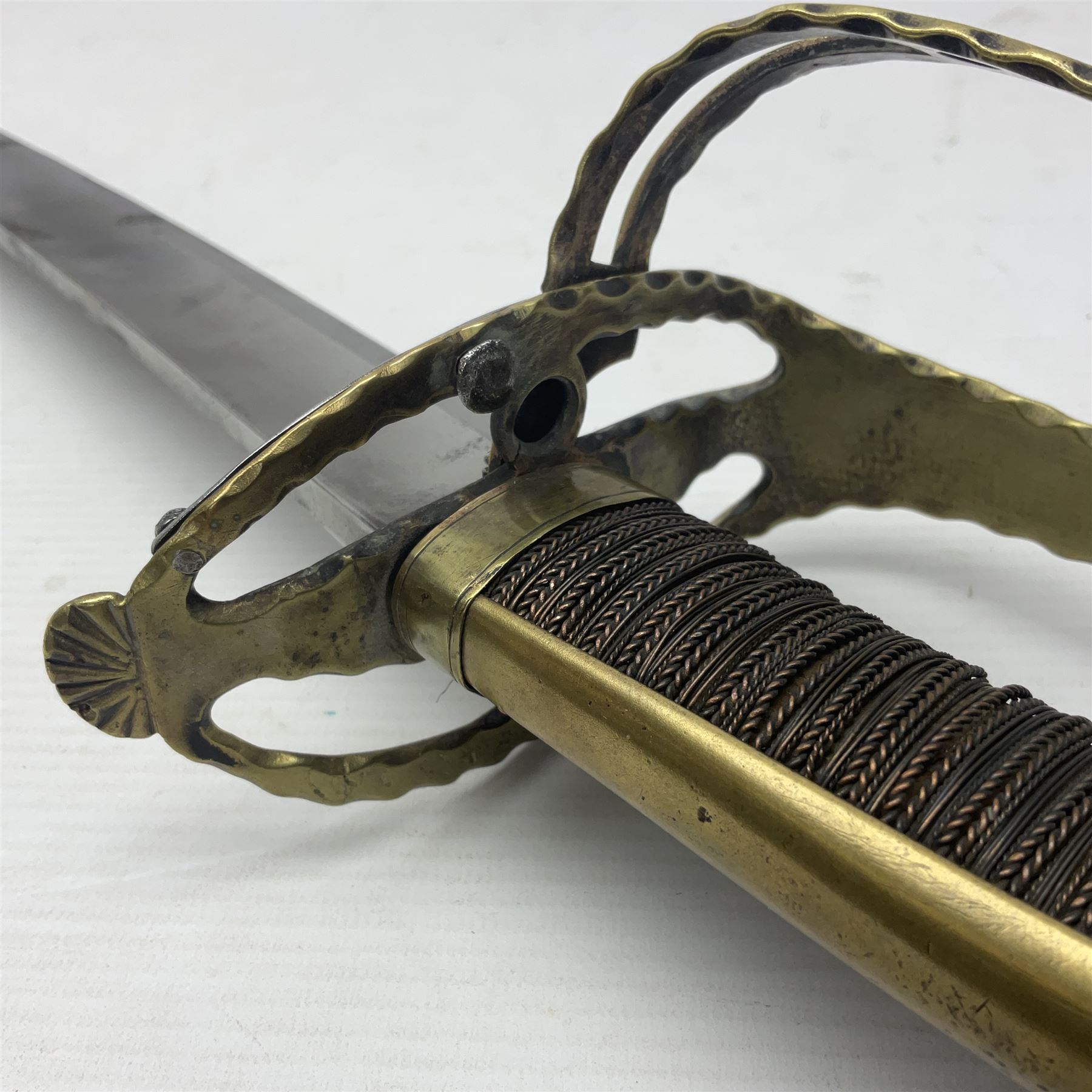 Late 18th century French 1st Empire Troupe a Pied Petit Montmorency Branch Tournante officer's sword, with 72.5cm slightly curving fullered blade, pierced brass hilt with lockable swivelling bar, fully wire-bound grip with lion head pommel, L88cm overall (no scabbard)