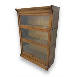 Early 20th century oak three-tier stacking library bookcase, enclosed by hinged and sliding glazed doors
