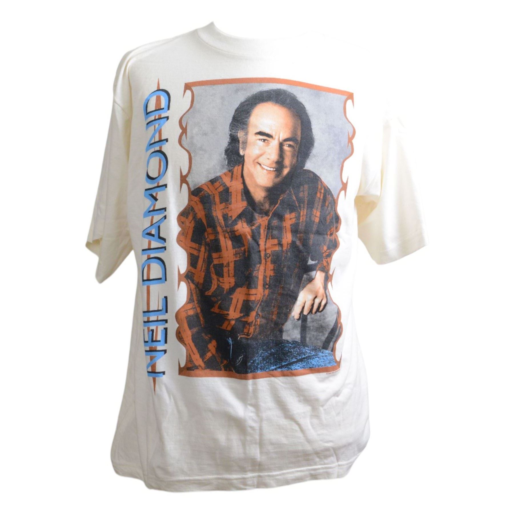 Neil Diamond tour memorabilia, including five t-shirts, cap, programmes, calendar and biography, together with a Neil Diamond In Concert poster, framed