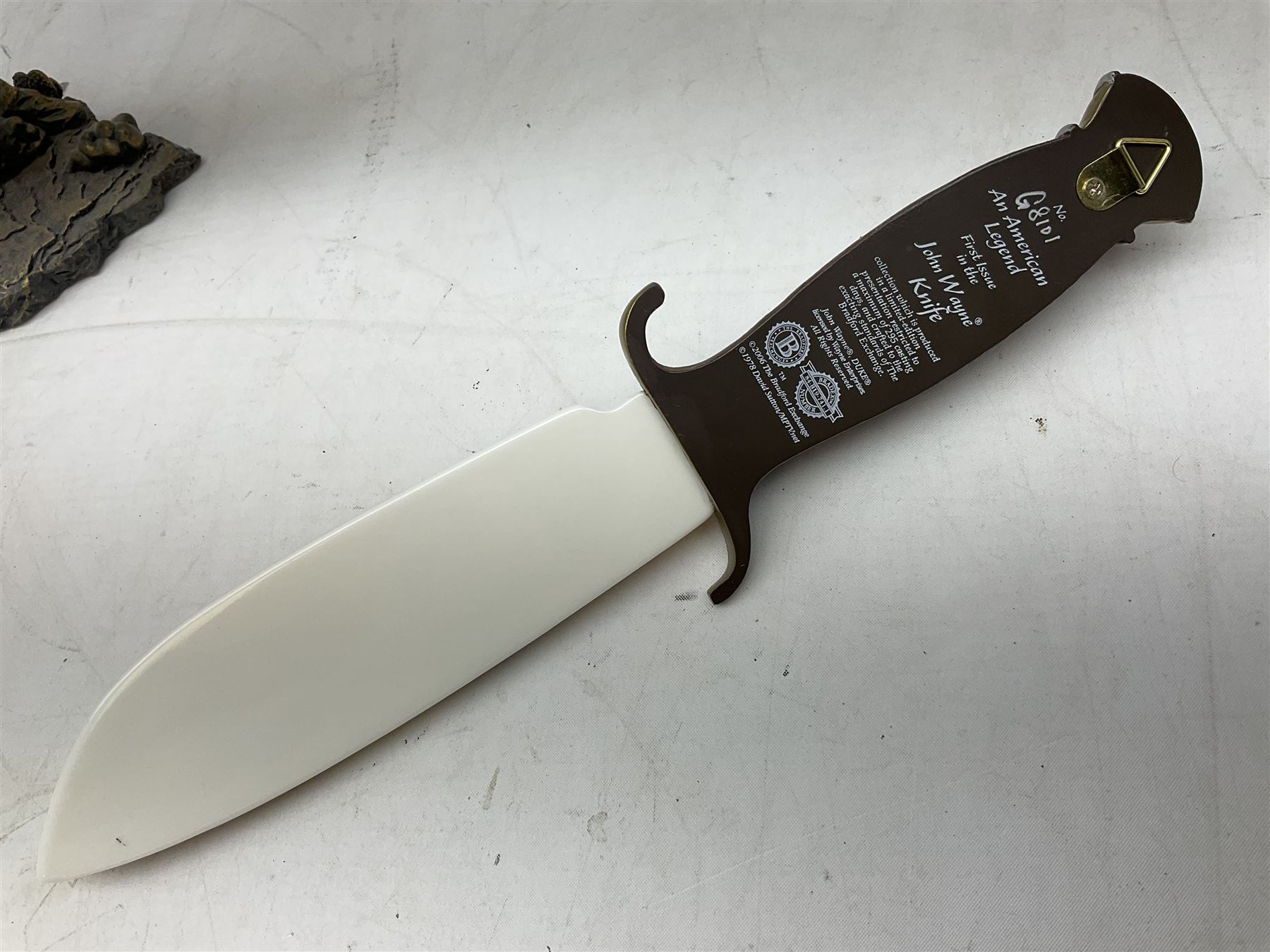 The Bradford Exchange John Wayne bowie decorative knife, L27cm and John Wayne Tall in the Saddle Galloping Thunder figure group